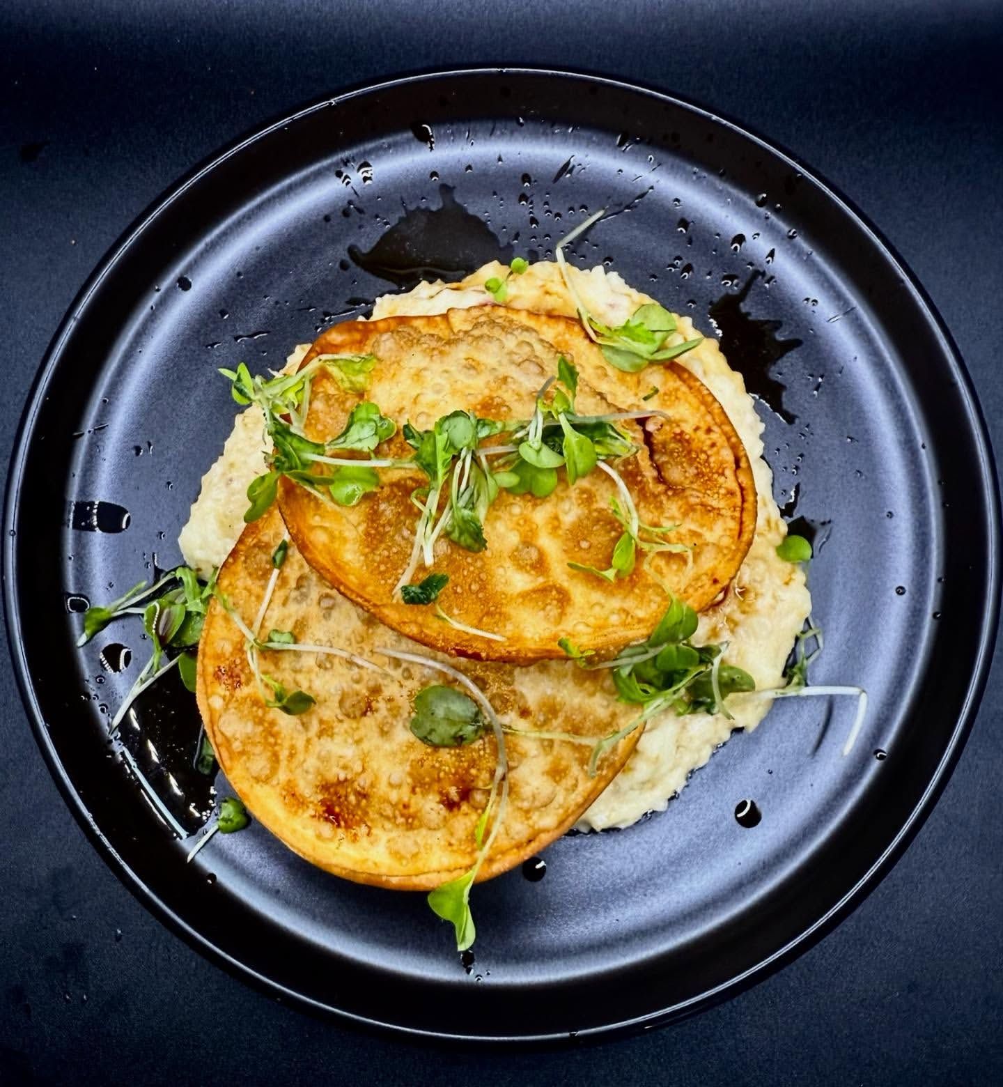 Crispy battered cuts of protein over creamy mash, sauced and herbed.